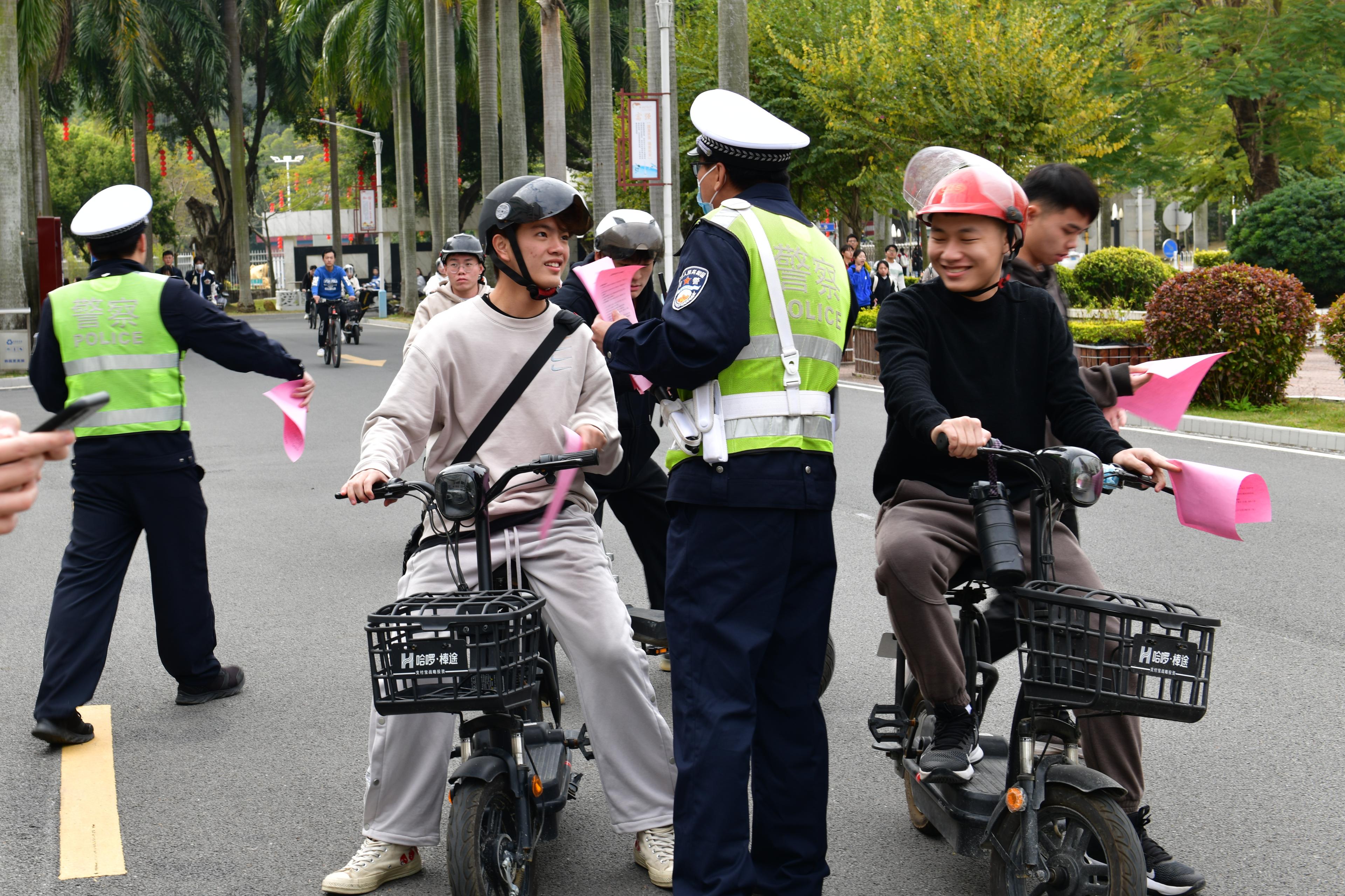 警官在學校東校區開展交通督導執法,一邊為路人散發交通安全宣傳資料